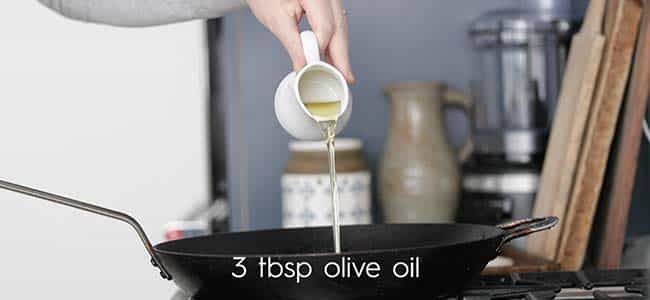 adding olive oil to a pan