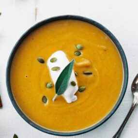 butternut soup in a bowl with a spoon