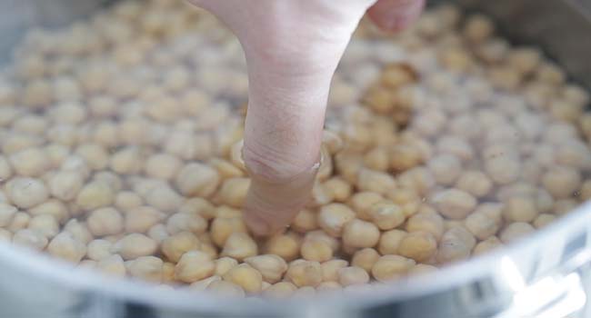 filling up a pot with water and garbanzo beans