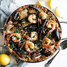 homemade seafood and chicken paella in a pan