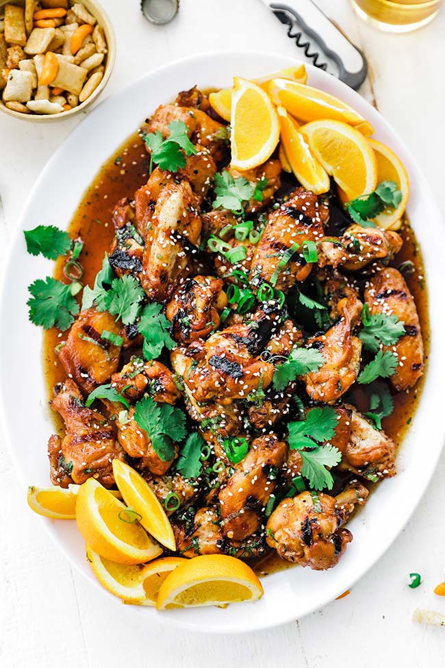 grilled chicken wings tossed in a honey chili garlic sauce on a plate