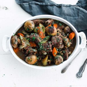 bowl of cubed beef with mushrooms and carrots