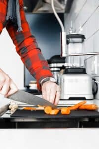 slicing carrots on a cutting board in the franke chef center