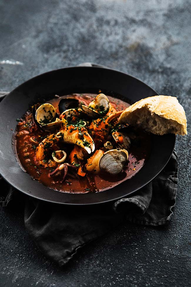 shellfish cooked in a tomato herb broth and served with bread