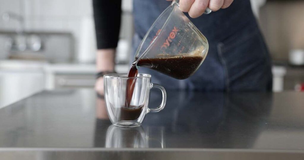 pouring pre-sweetened espresso to a cup