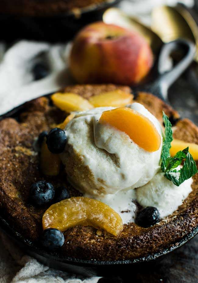 old fashioned peach cobbler served with mint and homemade whipped cream