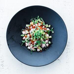 shrimp ceviche with vegetables and fruit in a plate