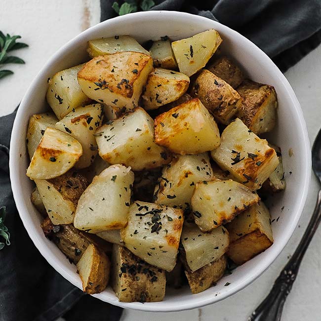 bowl of roasted potatoes with herbs