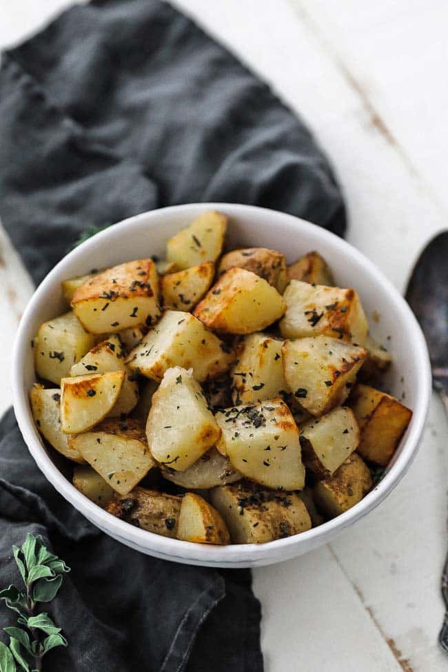 bowl with browned potatoes and herbs