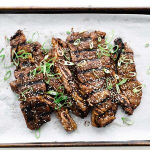 grilled short ribs on a sheet tray with parchment paper