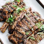 grilled kalbi with sesame seeds and green onions