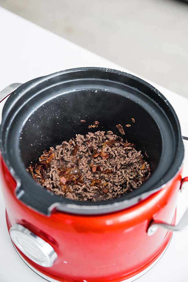 cooking the ground beef in a slow cooker for beer cheese dip
