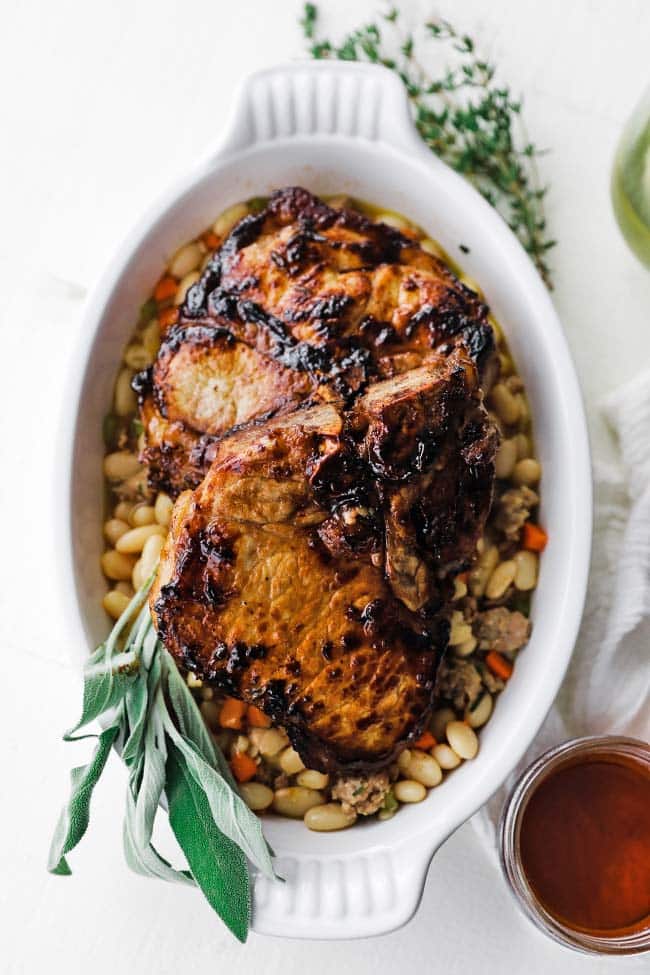 a cassoulet dish with sage pork chops and beans
