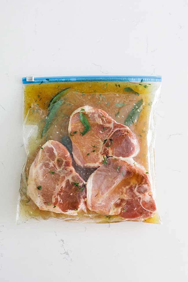 pork chops in a plastic bag with a marindade
