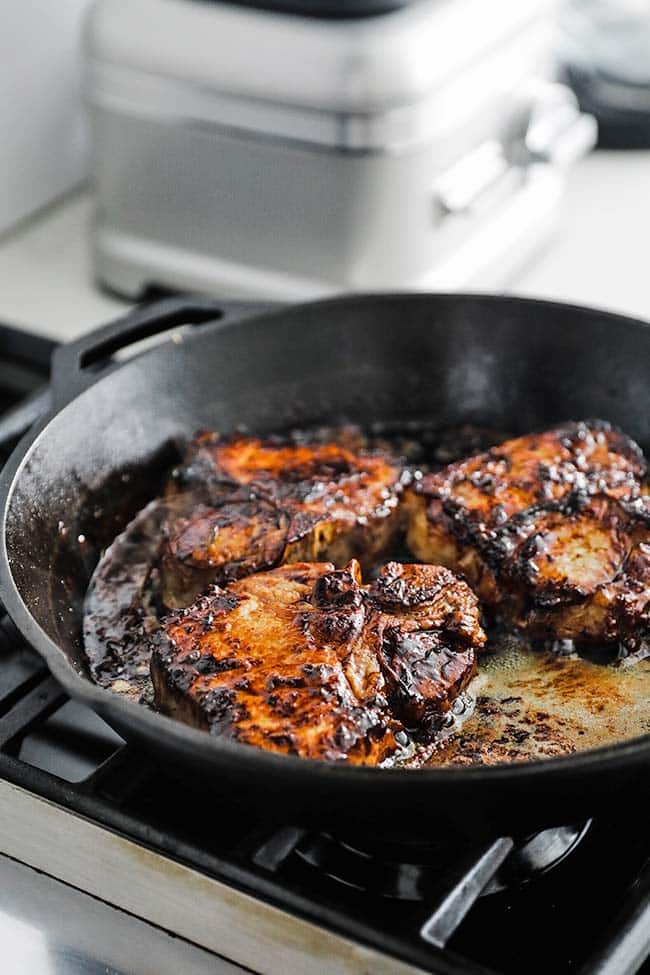 large cast iron skillet with roasted pork chops