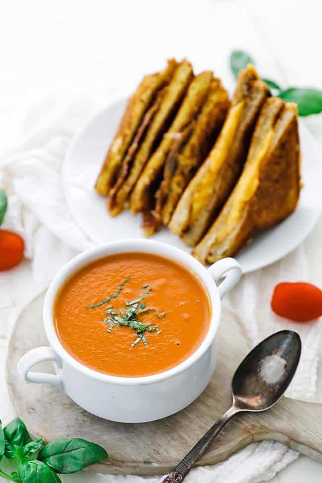 tomato soup with fresh herbs in a soup cup