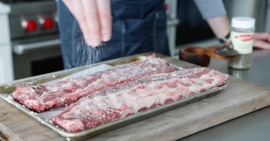 seasoning ribs with salt and pepper