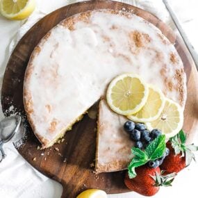 a lemon polenta cake with lemons and berries