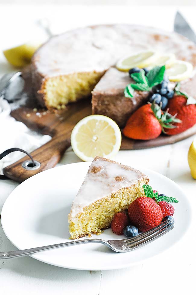 sliced of lemon polenta cake with berries