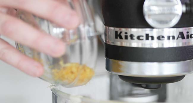 adding lemon zest to a stand mixer