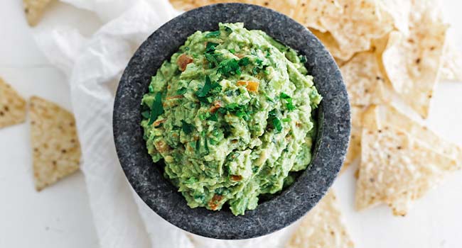 guacamole in a mortar with chips