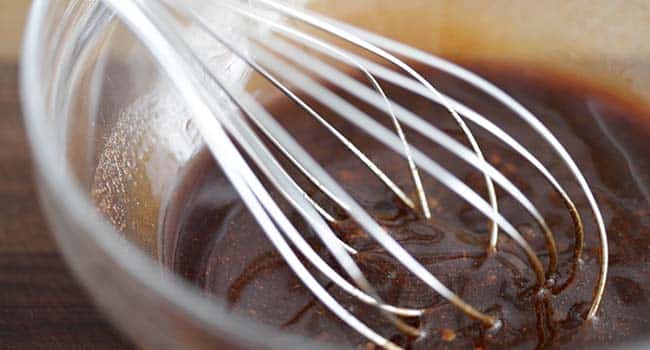 2whisking together a spice blend in a bowl