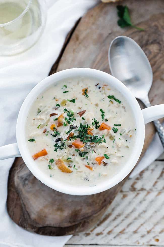 bowl of creamy soup with vegetables and parsley