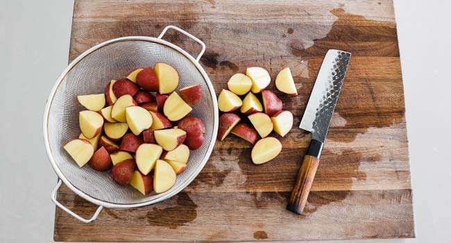 slicing red potatoes