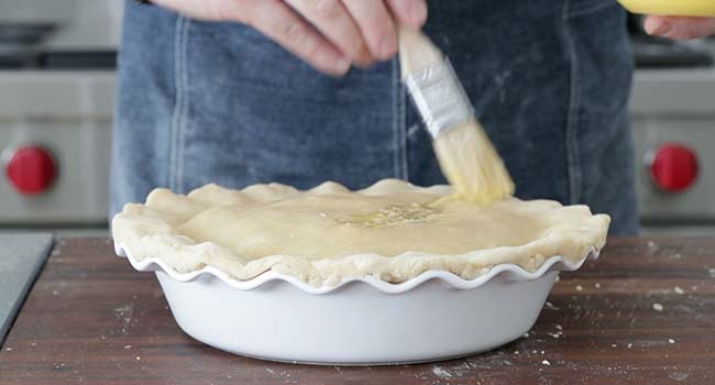 brushing a pot pie with egg wash