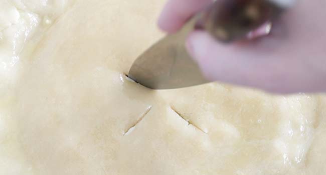 cutting slits into a pot pie