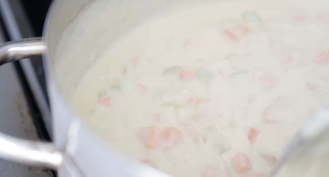 adding cream to a vegetable gravy