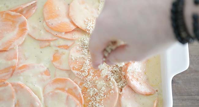 adding breadcrumbs to a sweet potato au gratin