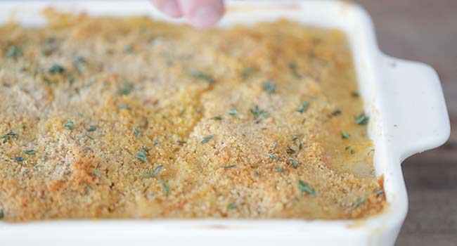 garnishing sweet potatoes au gratin with thyme