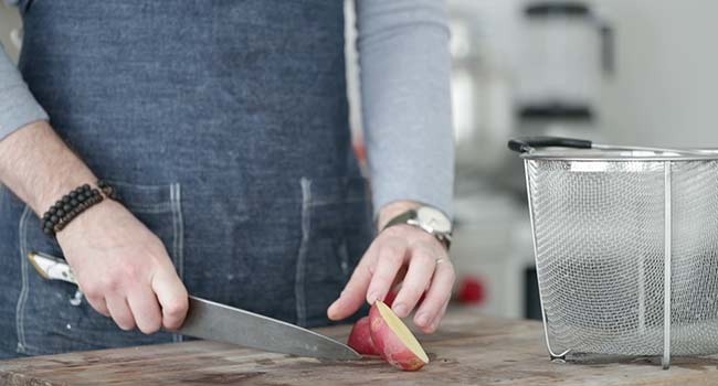 slicing red potatoes