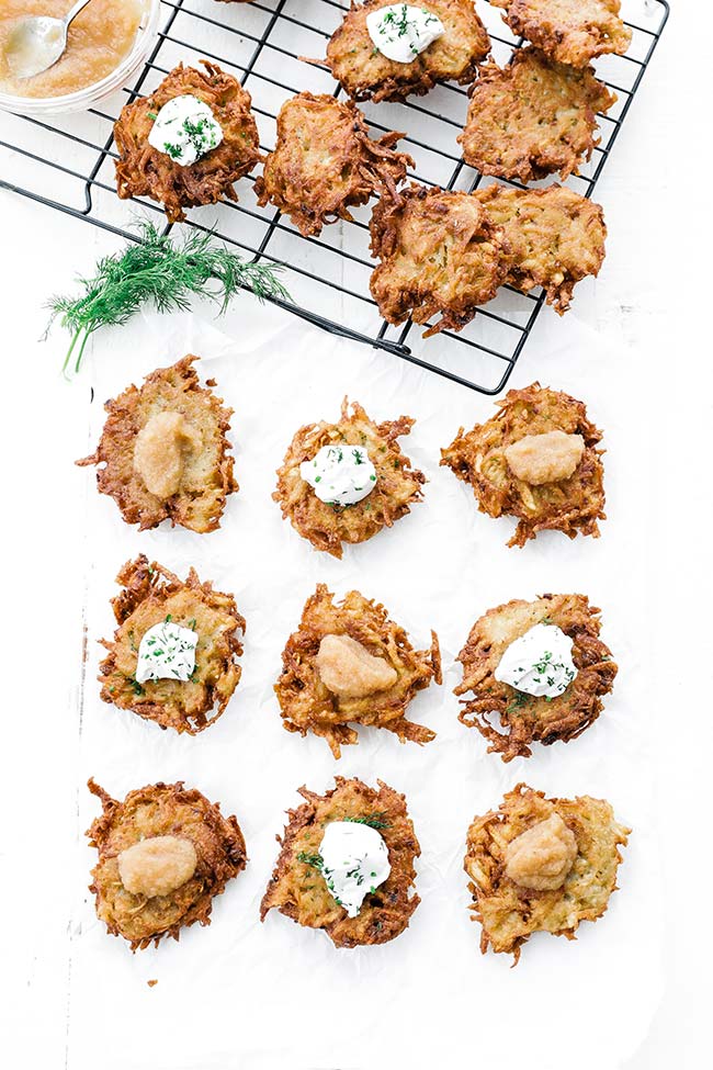 browned cooked latkes with sour cream and applesauce