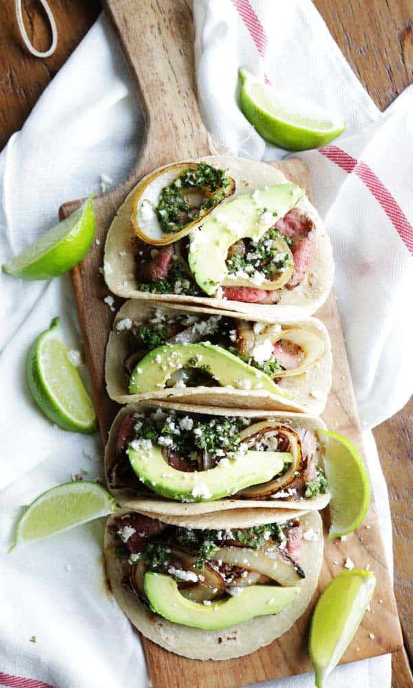 easy flank steak tacos recipe with chimichurri sauce, avocado and queso fresco