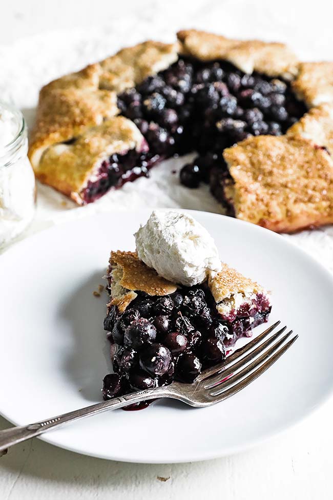 slice of blueberry crostata with whipped cream