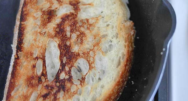 toasting sourdough bread in a pan