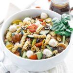 large bowl of italian pasta salad with fresh herbs