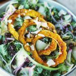 kale salad with squash in a bowl