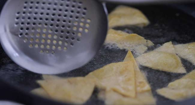 Frying corn tortilla chips in oil