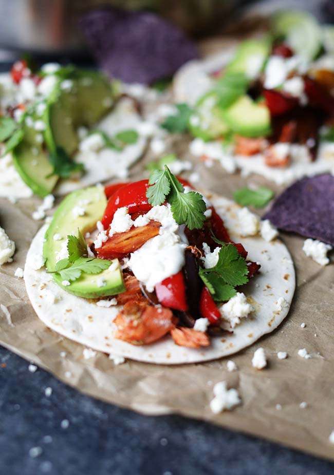 salmon fajita in a flour tortilla with cilantro, peppers and avocado