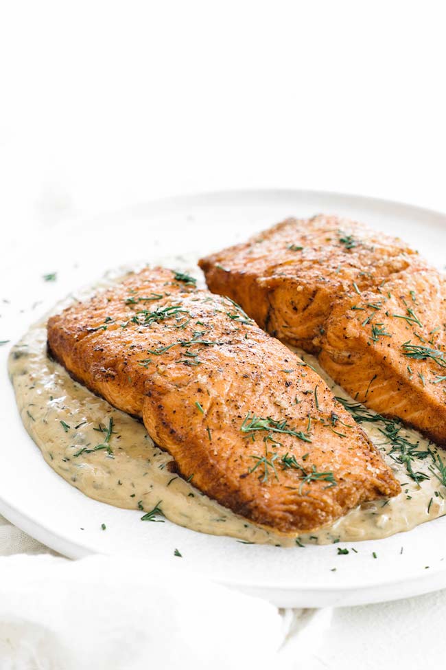pan seared salmon on a plate with butter sauce