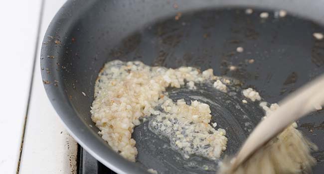 cooking shallots or garlic in a pan