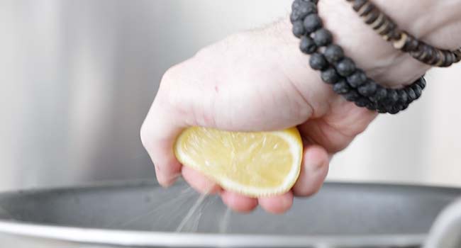 adding lemon juice to a pan