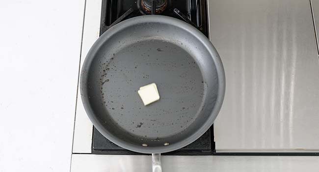 adding butter to a pan