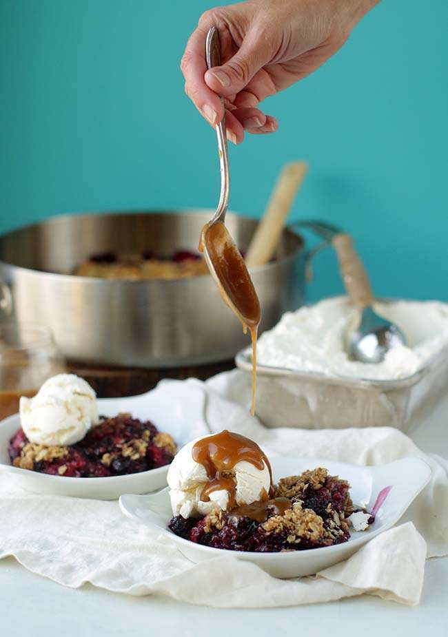 pouring caramel on ice cream and a berry crisp