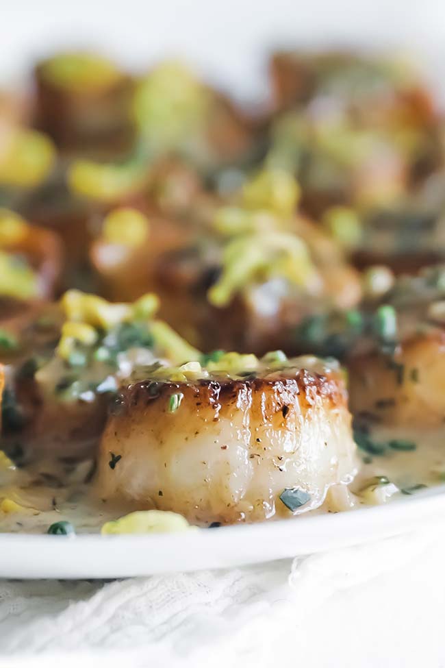 a pan-seared scallop with herb butter and lemon zest