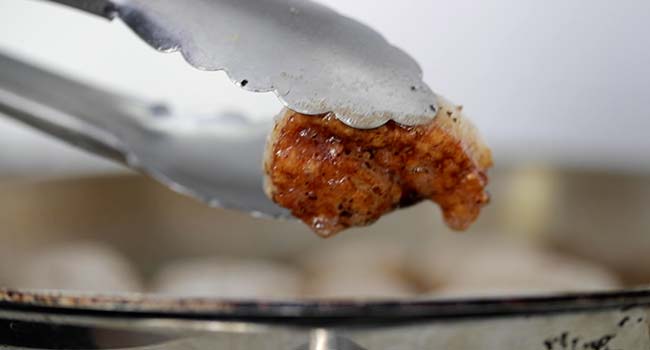 turning a browned scallop in a pan