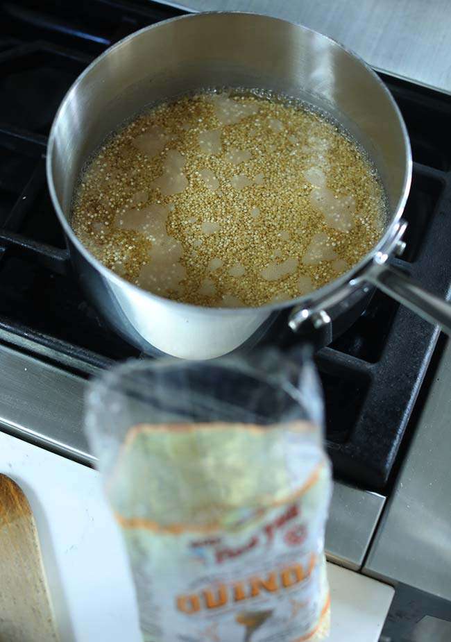 quinoa cooking in a pot with water on the stovetop
